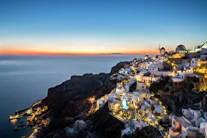 Long exposure sunset view over the whitewashed buildings and windmills of Oia, Santorini Long exposure sunset view over the whitewashed buildings and windmills of Oia, Santorini