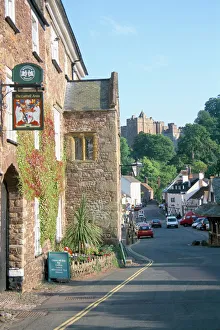 Luttrell Arms Hotel and Dunster Castle beyond, Dunster, Somerset, England Luttrell Arms Hotel and Dunster Castle beyond, Dunster, Somerset, England