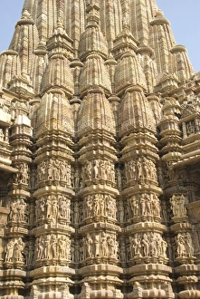 Detail of the main spire with some of the 646 erotic figures carved in sandstone on the Kandariya Mahadeva Temple Detail of the main spire with some of the 646 erotic figures carved in sandstone on the Kandariya Mahadeva Temple