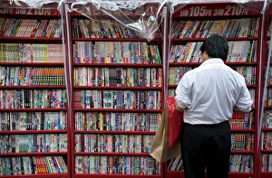 Man browsing Japanese manga comic books at a shop in Osaka, Japan, Asia Man browsing Japanese manga comic books at a shop in Osaka, Japan, Asia