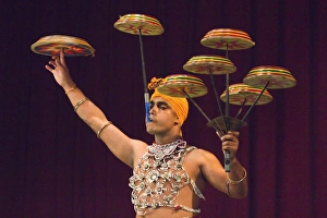 Man performing the Raban Dance and balancing drums in a tourist show at the Kandyan Arts Man performing the Raban Dance and balancing drums in a tourist show at the Kandyan Arts