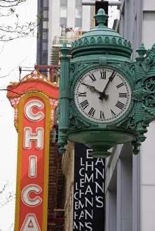 The Marshall Field Building Clock and Chicago Theatre behind, Chicago, Illinois The Marshall Field Building Clock and Chicago Theatre behind, Chicago, Illinois