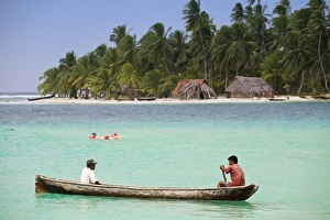 Men in dugout canoe near Devil Island, Comarca de Kuna Yala, San Blas Islands Men in dugout canoe near Devil Island, Comarca de Kuna Yala, San Blas Islands
