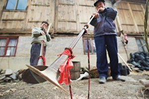 Men playing traditional horn instruments at a Lunar New Year festival in the Miao village of Qingman, Guizhou Province Men playing traditional horn instruments at a Lunar New Year festival in the Miao village of Qingman, Guizhou Province