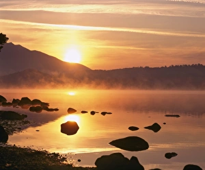 Mist rising on Derwent Water at sunrise, Lake District National Park, Cumbria Mist rising on Derwent Water at sunrise, Lake District National Park, Cumbria