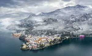 Images Dated 10th February 2021: Mist over Varenna old town and Lake Como after a snowfall in winter, aerial view