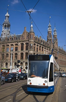 Modern tram with the Magna Plaza building behind, Amsterdam, Netherlands, Europe Modern tram with the Magna Plaza building behind, Amsterdam, Netherlands, Europe