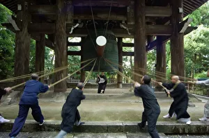 Temple Prints: Monks pulling ropes of a large temple bell Print