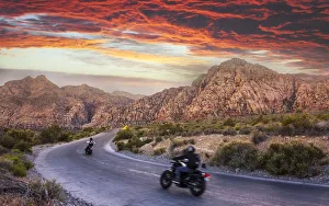 Motocycles driving through The Red Rock Canyon National Recreation Area at sunset Motocycles driving through The Red Rock Canyon National Recreation Area at sunset