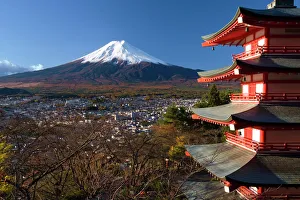 Mount Fuji capped in snow and the upper levels of a temple Mount Fuji capped in snow and the upper levels of a temple