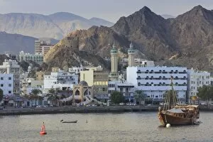 Images Dated 15th November 2015: Mutrah Corniche and entrance to Mutrah Souq, backed by mountains, viewed from the sea