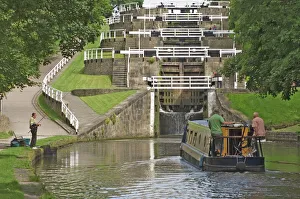 Narrow boat entering the bottom lock of the five lock ladder on the Liverpool Leeds canal Narrow boat entering the bottom lock of the five lock ladder on the Liverpool Leeds canal