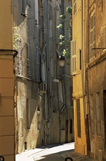 Narrow sunlit street in Old Aix, Aix-en-Provence, Bouches-de-Rhone, Provence-Alpes-Cote-d'Azur Narrow sunlit street in Old Aix, Aix-en-Provence, Bouches-de-Rhone, Provence-Alpes-Cote-d'Azur