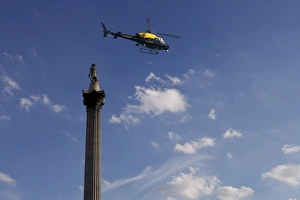 Prints of Nelsons Column and police helicopter, London, England, United Kingdom, Europe Police Prints: Nelson's Column Print with Police Helicopter Overhead