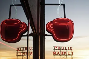 Neon coffee mug reflected in coffee shop window with the Pike Place Market behind Neon coffee mug reflected in coffee shop window with the Pike Place Market behind