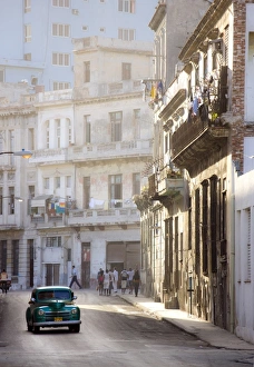 Old American car driving along quiet street in Havana Centro, Havana, Cuba Old American car driving along quiet street in Havana Centro, Havana, Cuba