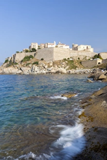 The old fortified citadel on the promontory surrounded by the clear sea, Calvi, Balagne Region The old fortified citadel on the promontory surrounded by the clear sea, Calvi, Balagne Region