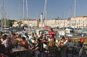 Open-air restaurant seating next to the ancient harbour at La Rochelle Open-air restaurant seating next to the ancient harbour at La Rochelle