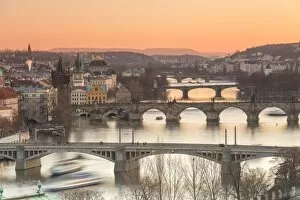 Images Dated 3rd December 2016: Orange sky at sunset on the historical bridges and buildings reflected on Vltava River