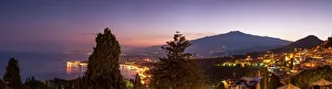 Panoramic view of Mount Etna and Giardini Naxos at dusk from Taormina, Sicily, Italy Panoramic view of Mount Etna and Giardini Naxos at dusk from Taormina, Sicily, Italy