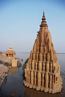 Partially submerged tilted Shiva temple below the ghats Partially submerged tilted Shiva temple below the ghats