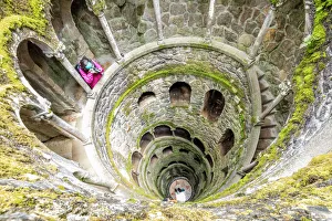 Photographer at the top of the spiral stairs inside the towers of Initiation Well Photographer at the top of the spiral stairs inside the towers of Initiation Well