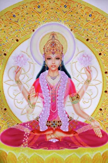 Picture of Lakshmi, goddess of wealth and consort of Lord Vishnu, sitting holding lotus flowers Picture of Lakshmi, goddess of wealth and consort of Lord Vishnu, sitting holding lotus flowers