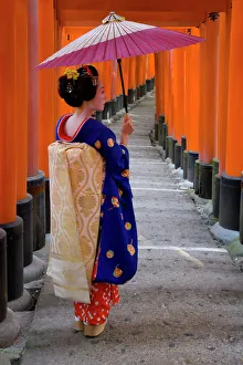 Portrait of a geisha holding an ornate umbrella at Portrait of a geisha holding an ornate umbrella at
