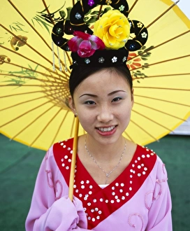 Portrait of a young woman holding parasol, smiling Portrait of a young woman holding parasol, smiling