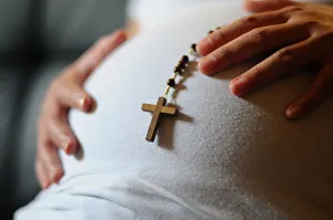 Pregnant woman with prayer beads, Paris, France, Europe Pregnant woman with prayer beads, Paris, France, Europe