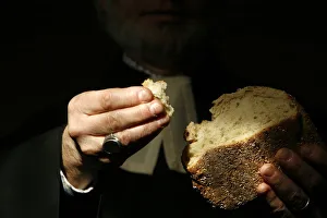 Protestant minister holding Communion bread, Geneva, Switzerland, Europe Protestant minister holding Communion bread, Geneva, Switzerland, Europe