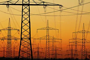 Pylons and power lines in morning light, Germany, Europe Pylons and power lines in morning light, Germany, Europe