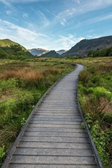 A raised path in the Borrowdale Valley with Castle Crag the prominent hill in the centre of image A raised path in the Borrowdale Valley with Castle Crag the prominent hill in the centre of image