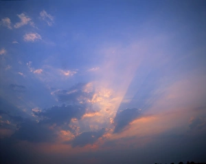 Natural World Landscapes Prints: Rays of light bursting through clouds in a blue sky