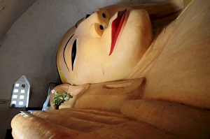 Reclining giant Buddha in a temple of the ruined city of Bagan, Myanmar, Asia Reclining giant Buddha in a temple of the ruined city of Bagan, Myanmar, Asia