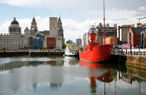 The red lightship at Canning Dock next to Albert Dock with the Liver building in The red lightship at Canning Dock next to Albert Dock with the Liver building in