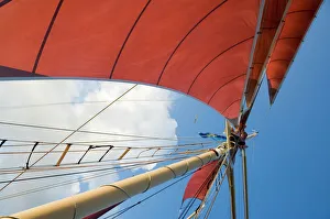 Red sails on sailboat that takes tourists out for sunset cruise Red sails on sailboat that takes tourists out for sunset cruise
