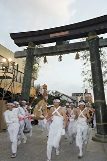 Rice bales being carried through a torii gate at Hadaka Matsuri (Naked Festival) Rice bales being carried through a torii gate at Hadaka Matsuri (Naked Festival)