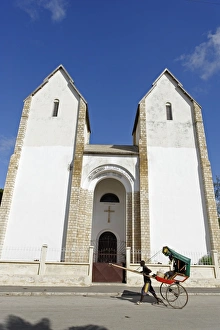 Rickshaw passing Lutheran Church, Toliara (Tulear), capital of the Atsimo-Andrefana Rickshaw passing Lutheran Church, Toliara (Tulear), capital of the Atsimo-Andrefana