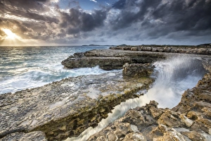 Central America Coastal Scenery Prints: Rocks and crashing waves at Devils Bridge, a natural arch carved by the sea, Antigua