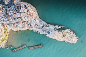 Rooftops of white buildings by the turquoise sea from above, Vieste, Foggia province Rooftops of white buildings by the turquoise sea from above, Vieste, Foggia province