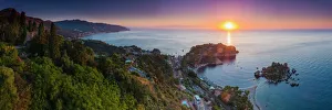The Sicilian coast at sunrise, showing Isola Bella Beach, Taormina, Sicily, Italy, Mediterranean, Europe The Sicilian coast at sunrise, showing Isola Bella Beach, Taormina, Sicily, Italy, Mediterranean, Europe