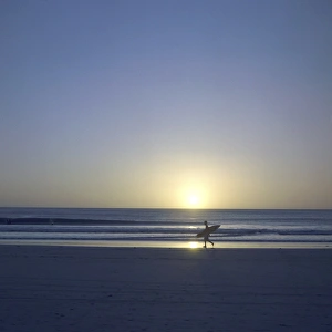 Silhouette of surfer walking on Avellanas Beach, Nicoya Peninsula, Costa Rica Silhouette of surfer walking on Avellanas Beach, Nicoya Peninsula, Costa Rica