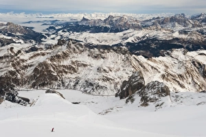 Skiers descend from the top of Marmolada in the Dolomites, Italy, Europe Skiers descend from the top of Marmolada in the Dolomites, Italy, Europe