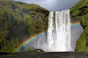 Skogafoss waterfall with rainbow in summer sunshine, South coast, Iceland, Polar Regions Skogafoss waterfall with rainbow in summer sunshine, South coast, Iceland, Polar Regions