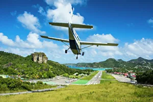 Small airplane landing at the airport of St. Barth (Saint Barthelemy), Lesser Antilles Small airplane landing at the airport of St. Barth (Saint Barthelemy), Lesser Antilles