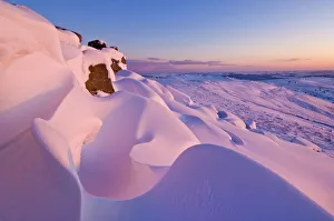 Snow covered moorland at sunset on Stanage Edge, Peak District National Park Snow covered moorland at sunset on Stanage Edge, Peak District National Park