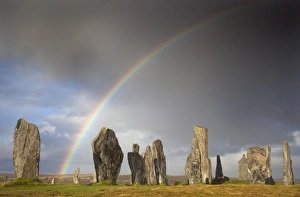 Standing Stones of Callanish bathed in sunlight with a rainbow arching across the sky in the background, near Carloway Standing Stones of Callanish bathed in sunlight with a rainbow arching across the sky in the background, near Carloway