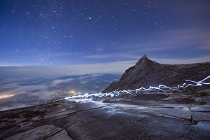 Stars and torch lights illuminating hiking trail, Kinabalu National Park (4095m) Stars and torch lights illuminating hiking trail, Kinabalu National Park (4095m)