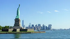 Statue of Liberty and Liberty Island with Manhattan skyline in view, New York City, New York, United States of America Statue of Liberty and Liberty Island with Manhattan skyline in view, New York City, New York, United States of America